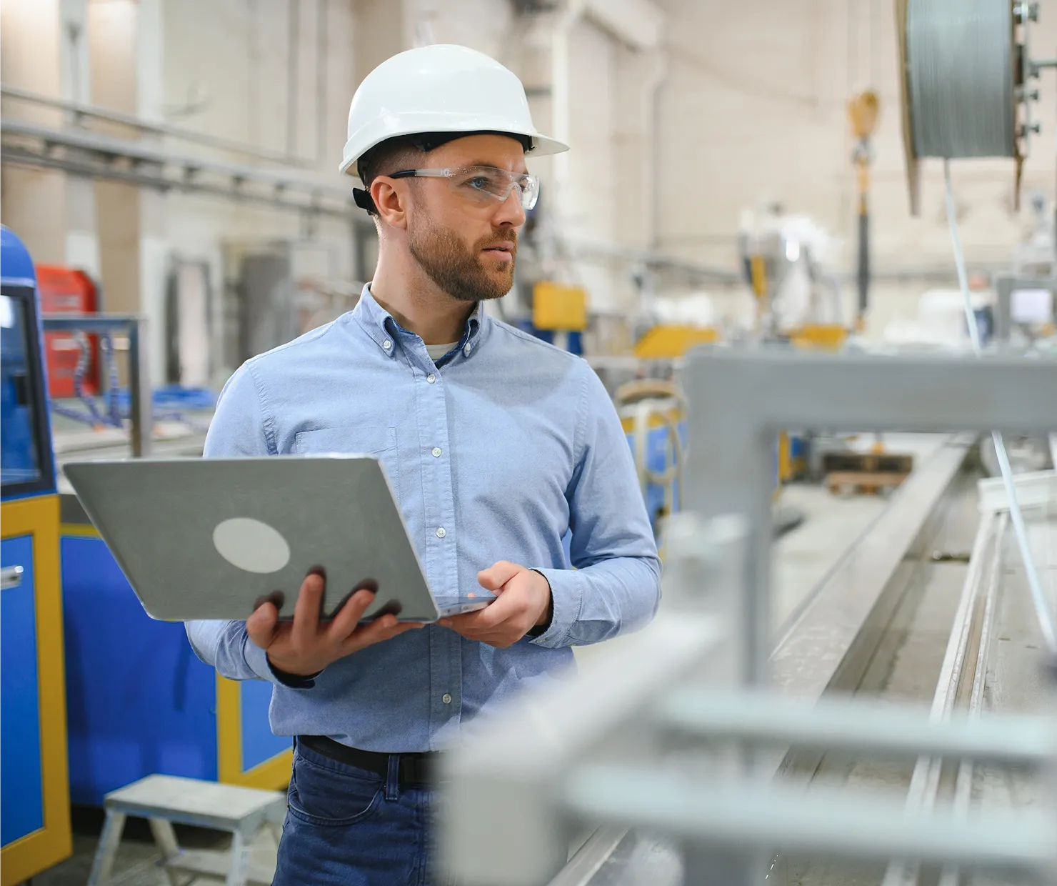 Middle-aged men working on a laptop in a warehouse